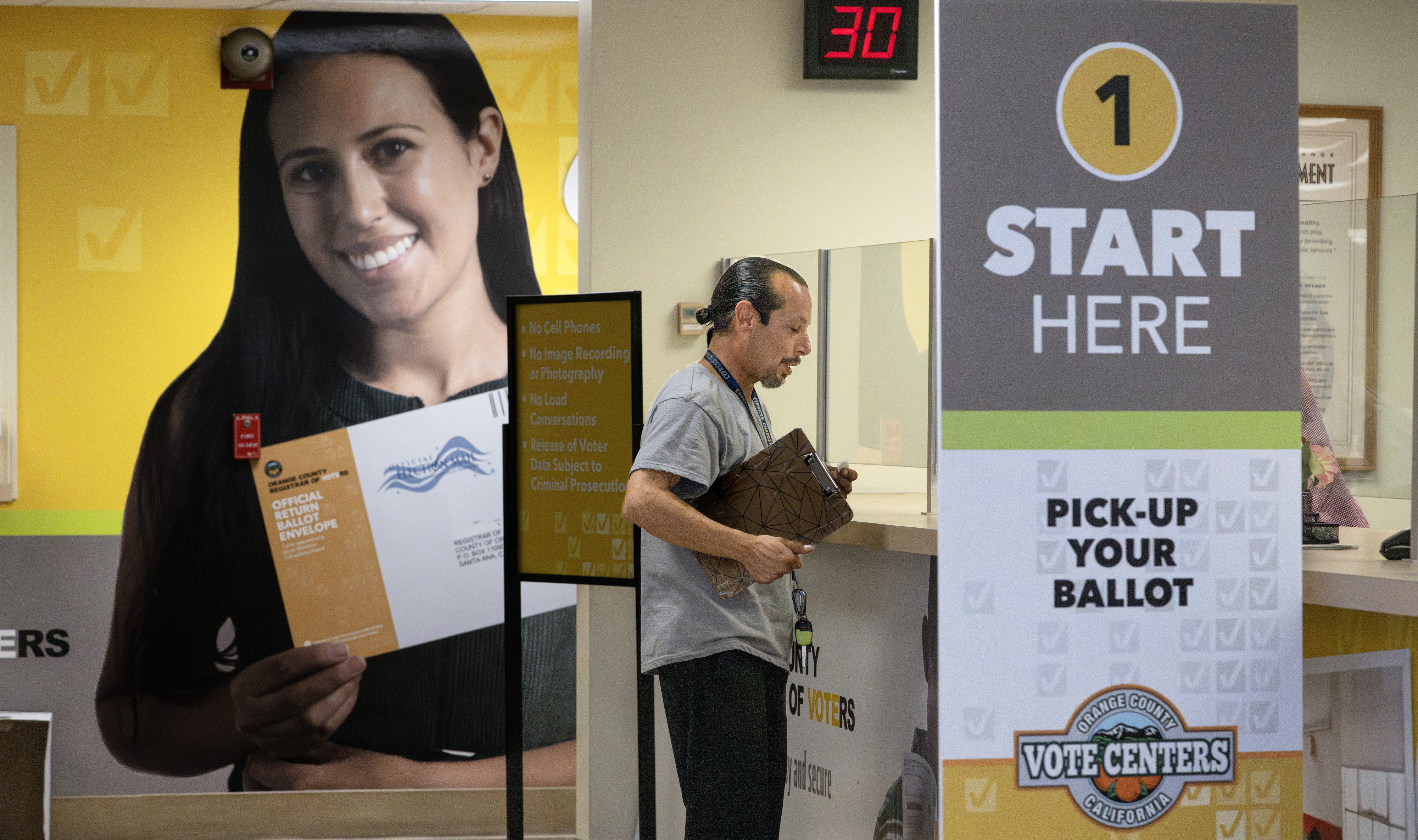Tony Castro drops off his ballot at the Registrar of...