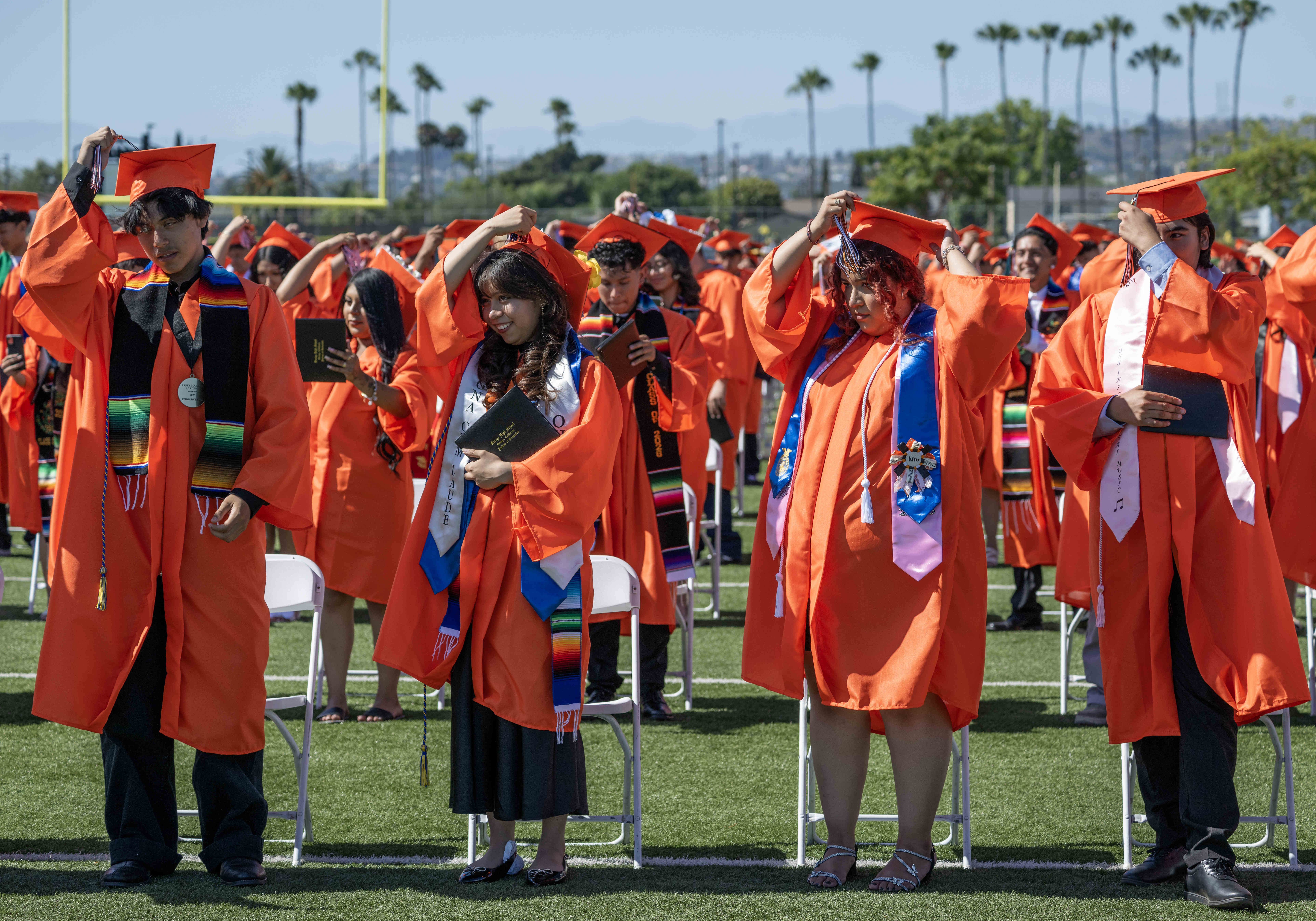 Orange High School graduates turn their tassels from right to...