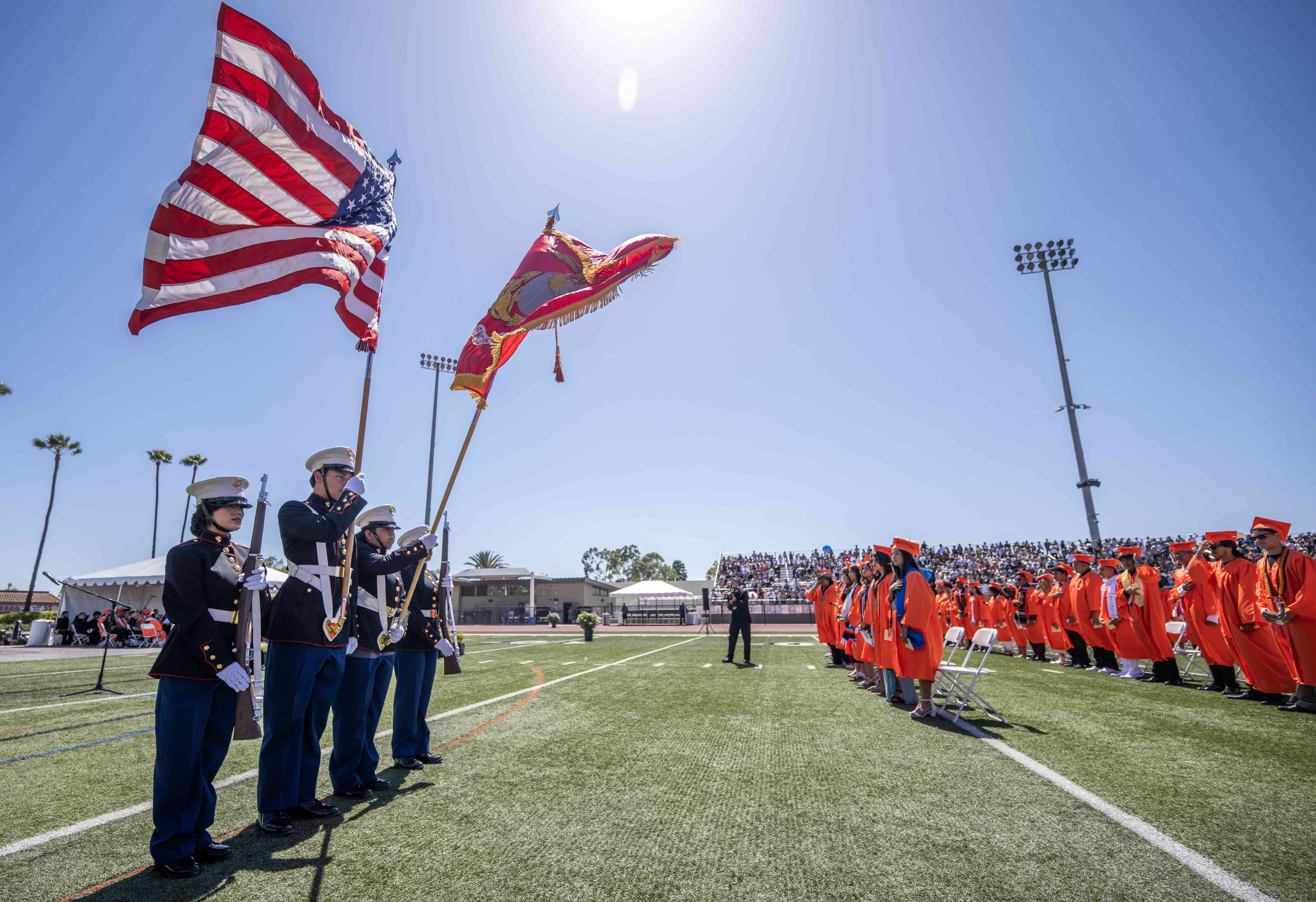 A Marine Corps Jr. R.O.T.C. Color Guard presents the flag...