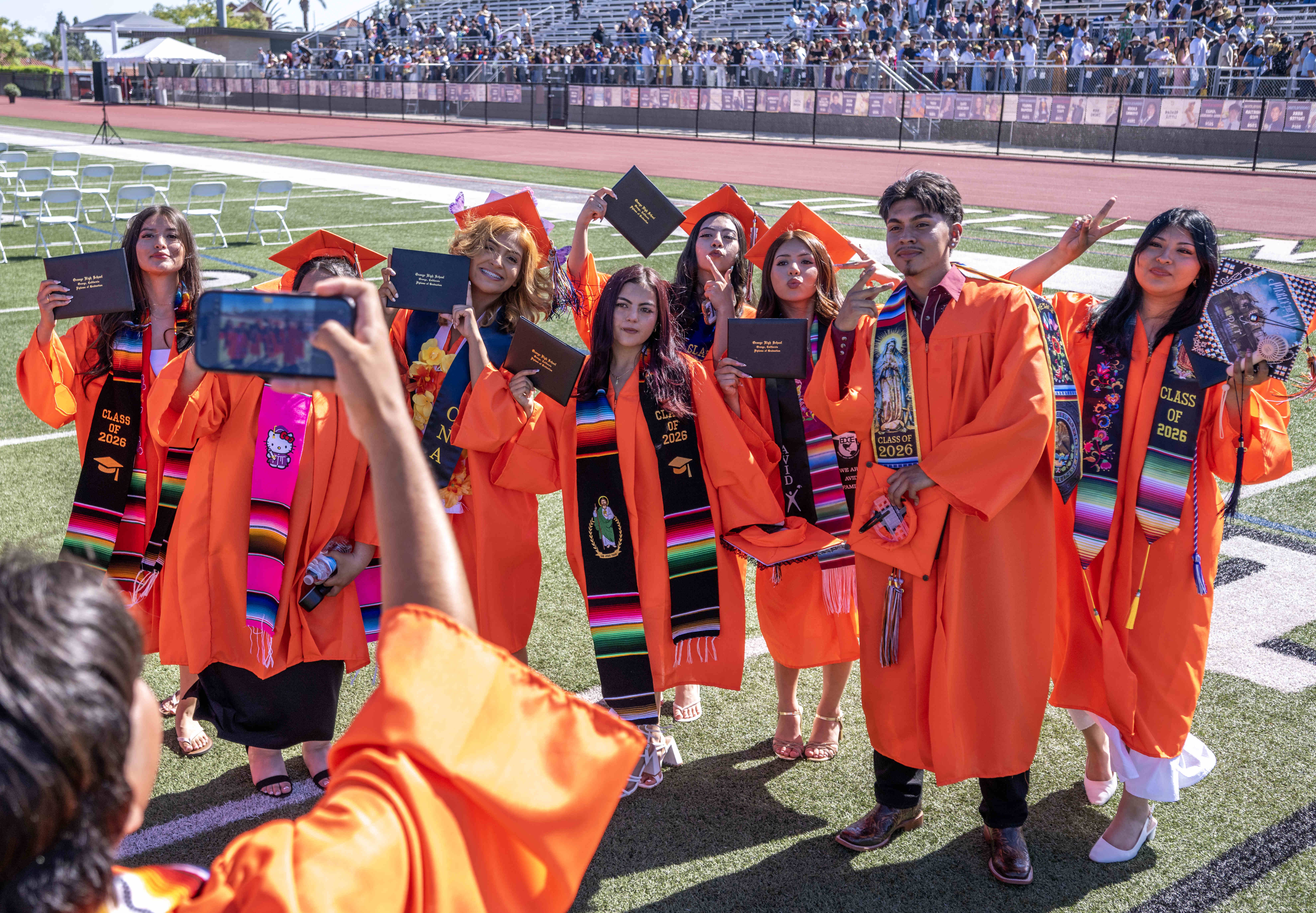Orange High School graduates celebrate together following their graduation ceremony...