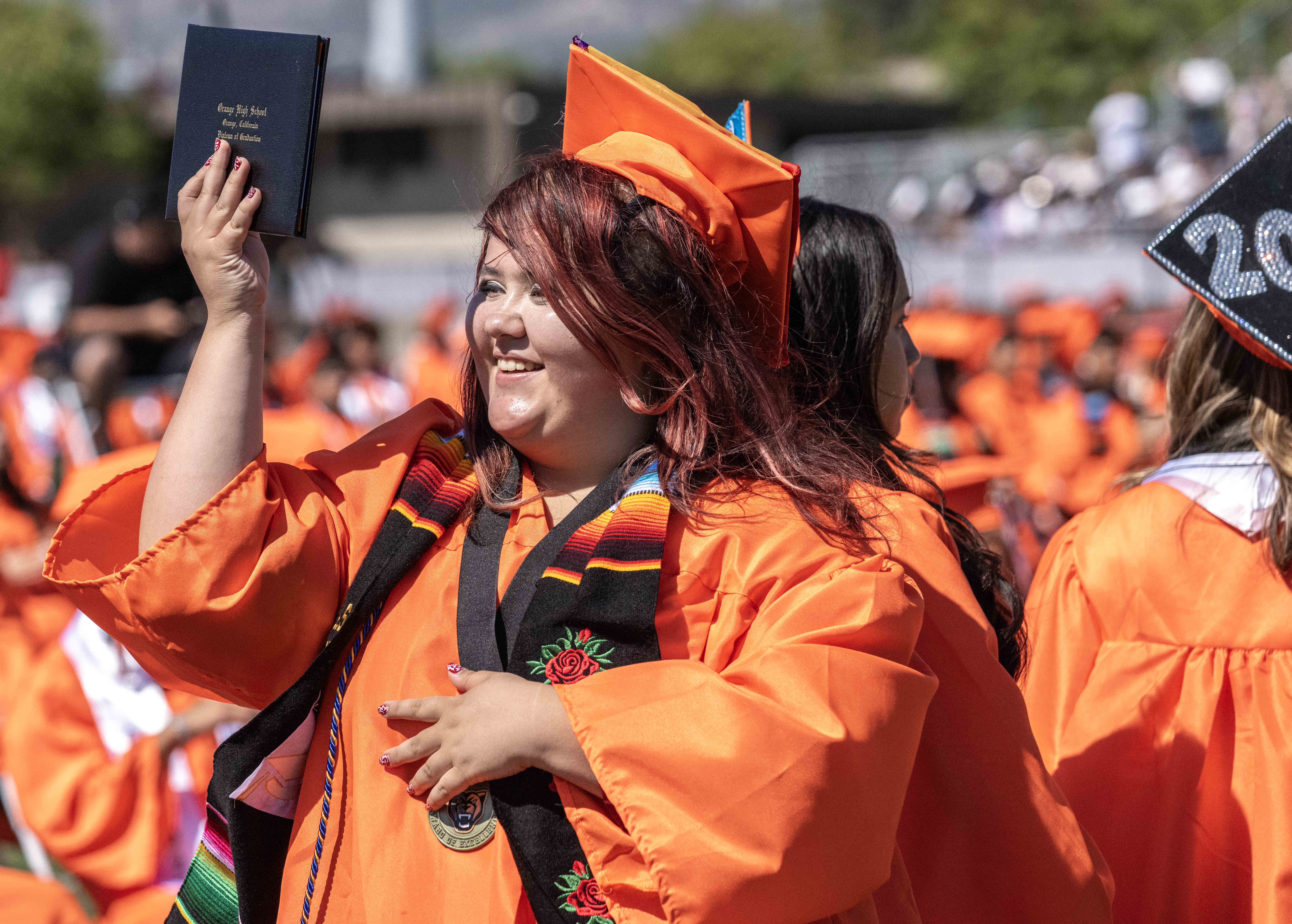 Eliana Martinez shows off her new diploma during Orange High...