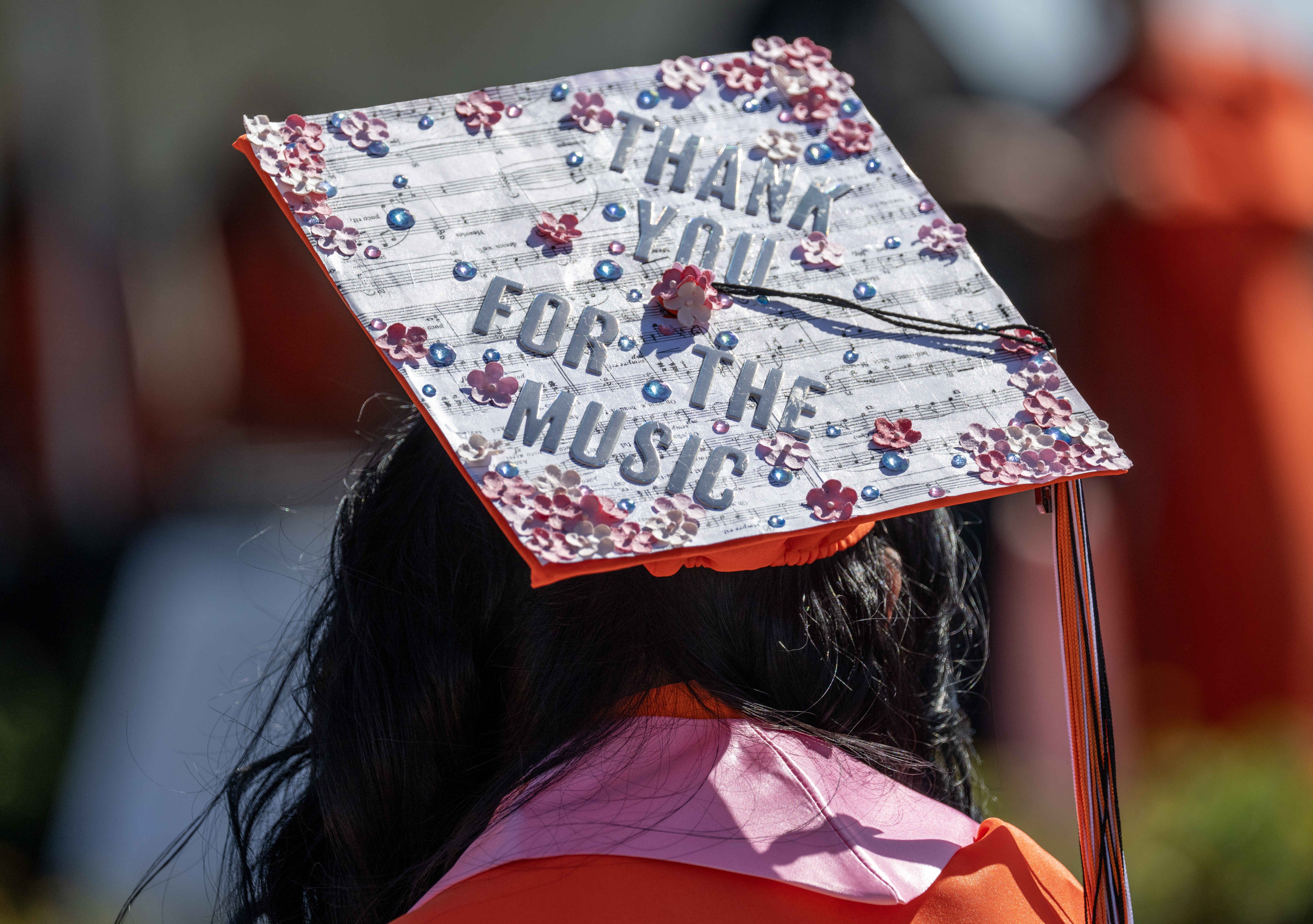 One Orange High School graduate sports a cap that reads,...