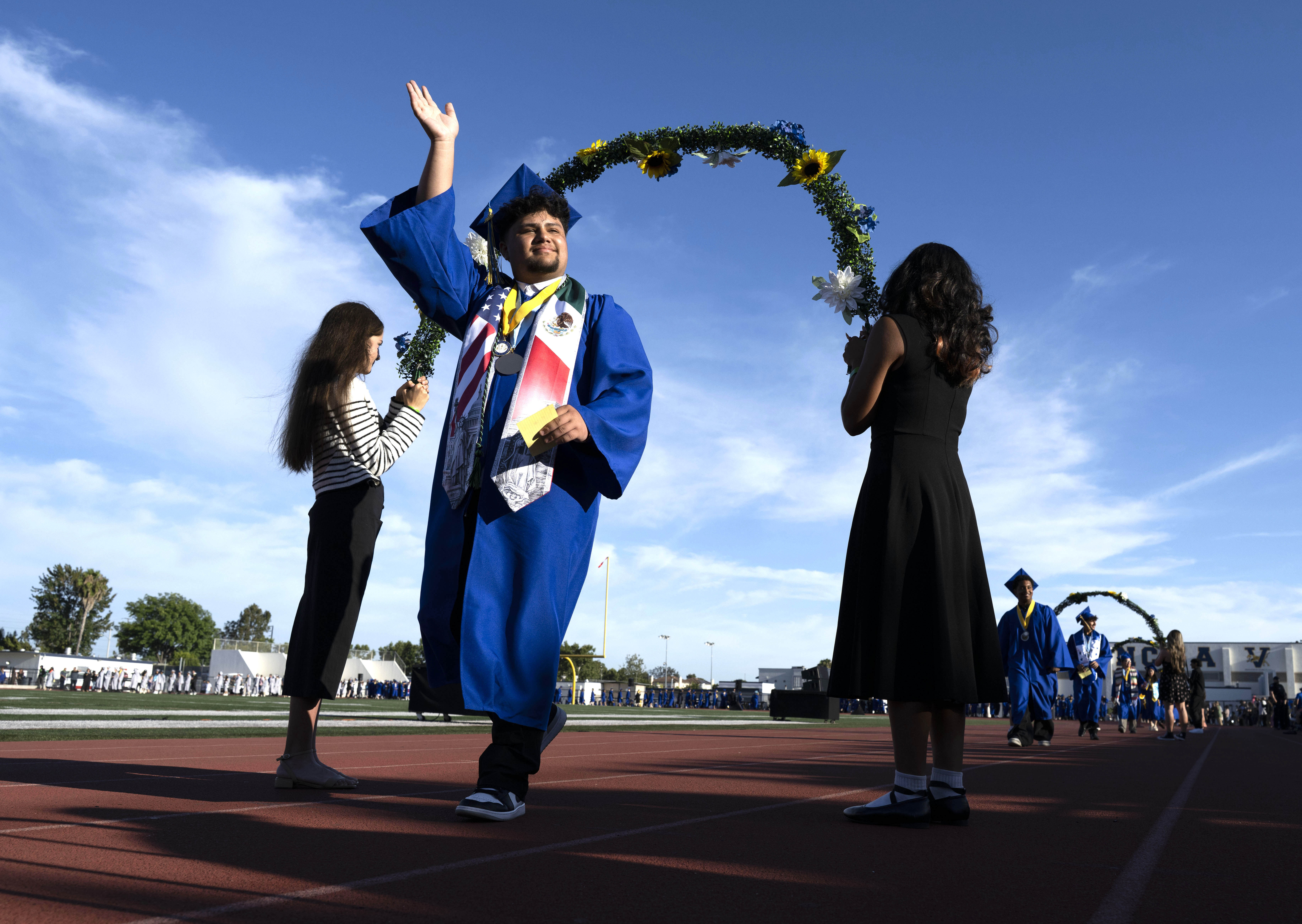 As he enters Bradford Stadium, a graduate waves to his...