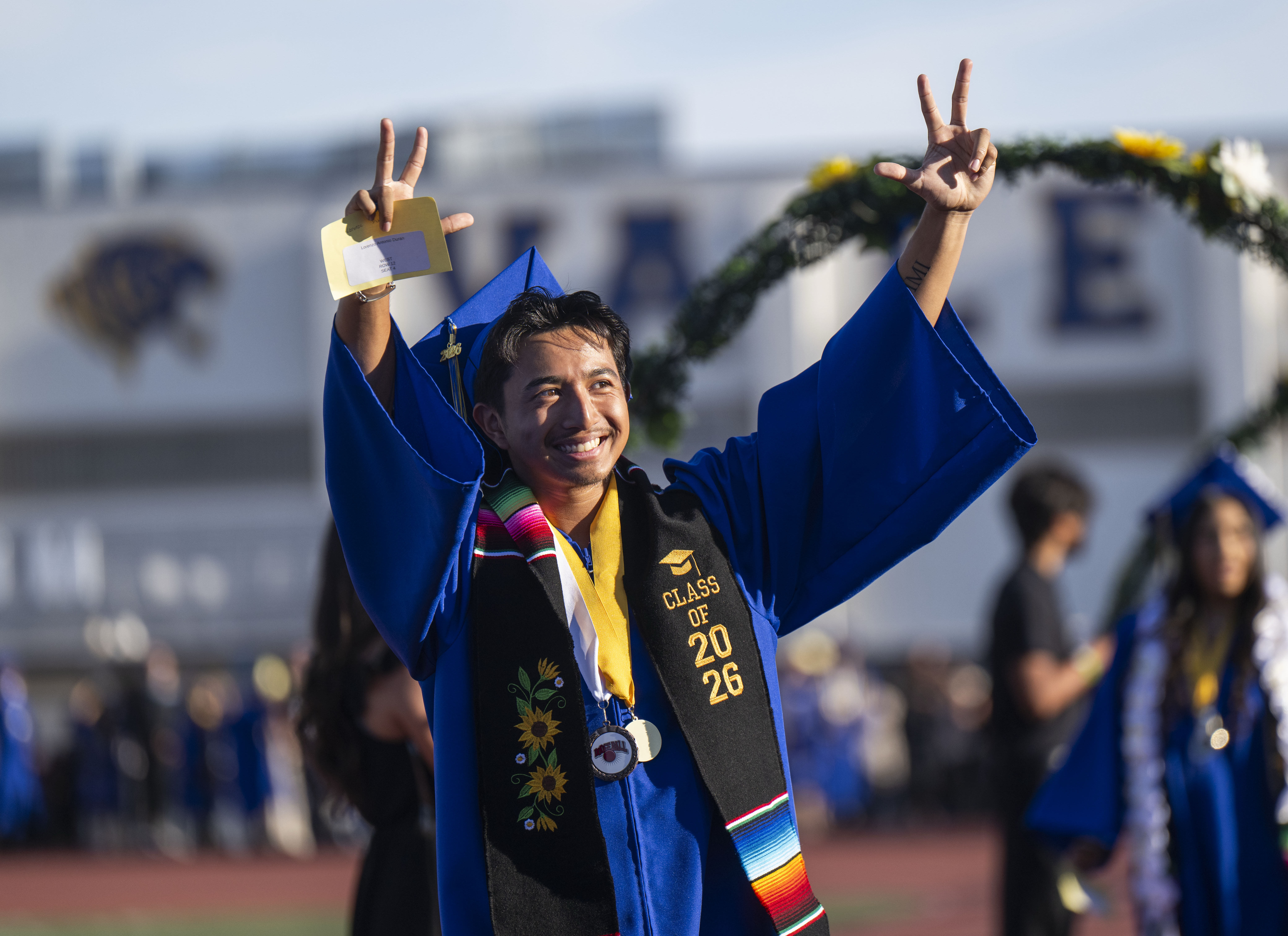 Graduate Lorenzo Duran takes in the experience as he enters...