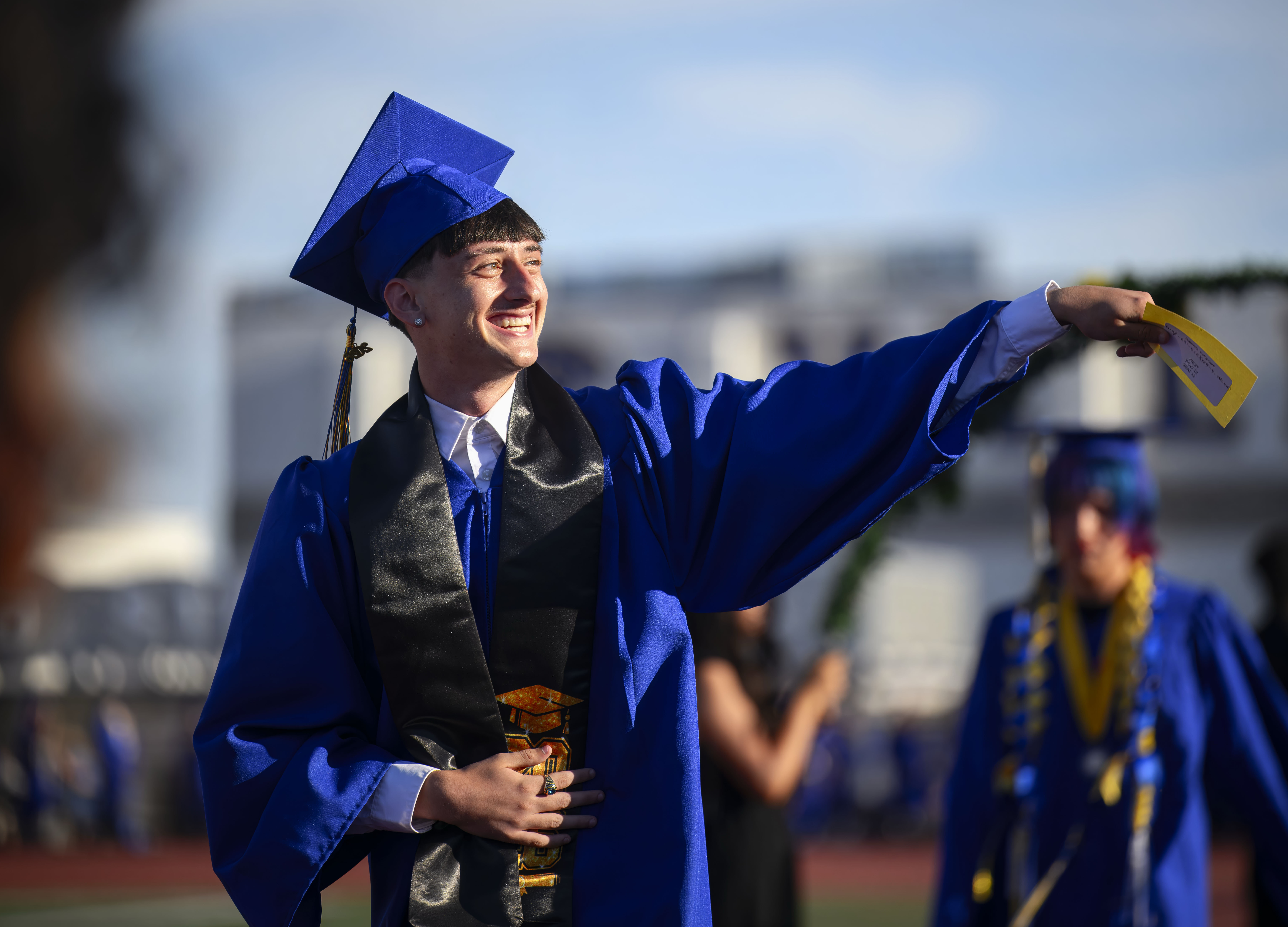 Graduate Gabriele Fatticcioni waves to his family as he enters...