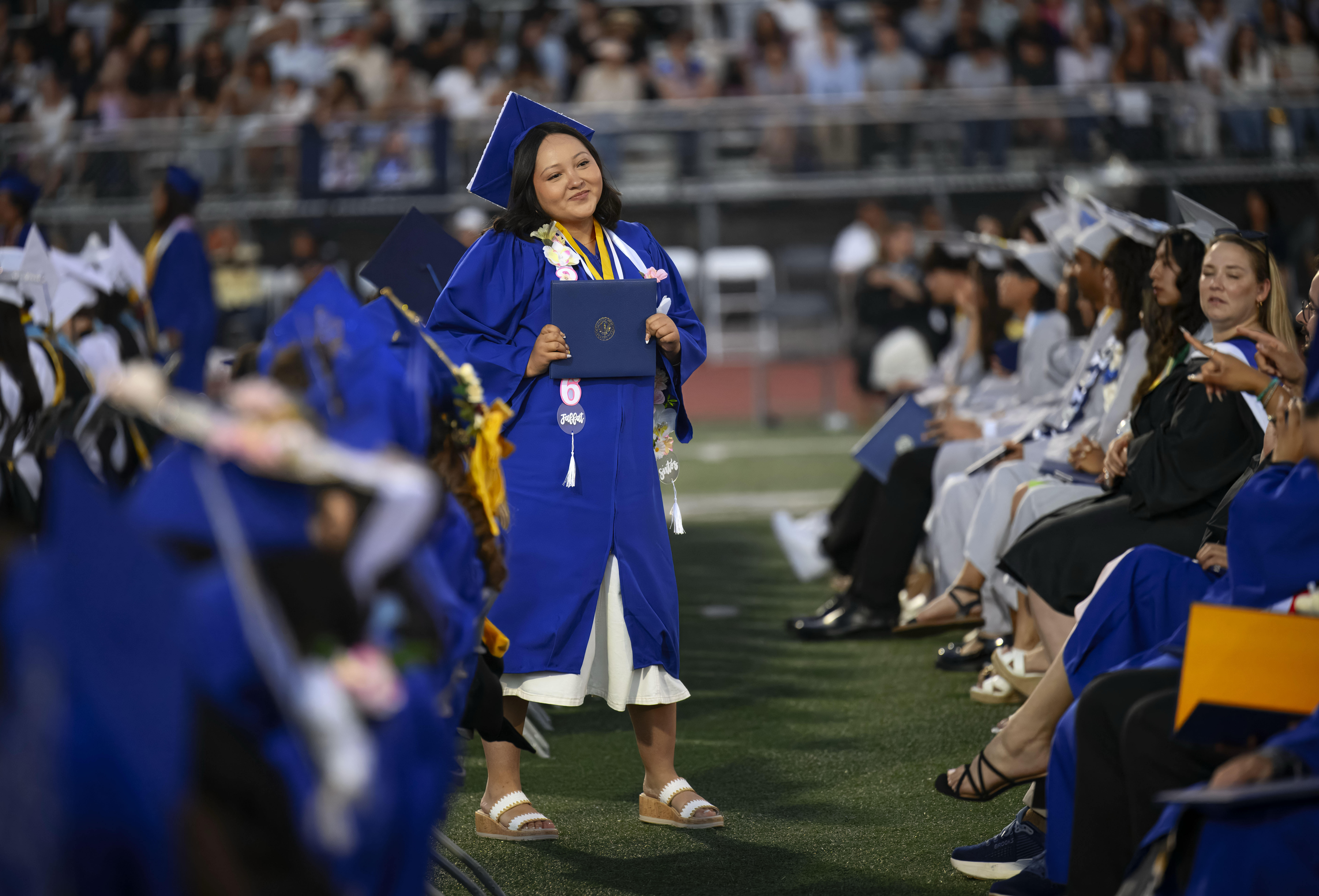 A graduate pauses to let a friend take her photo...