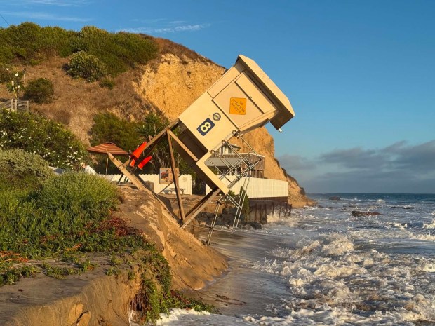 A lifeguard tower nearly tipped into the ocean at Crystal Cove State Beach near the historic cottages as big waves pounded the coast on Friday, June 12. (Courtesy of Mark Girardeau)