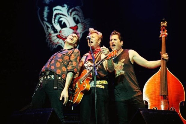 Singer-songwriter and Stray Cats bassist Lee Rocker (far right, pictured with fellow Stray Cats Brian Setzer, center, and Slim Jim Phantom) is releasing his latest solo album, "Gather Round," on Friday, Jan. 22. (Photo courtesy of Stray Cats)