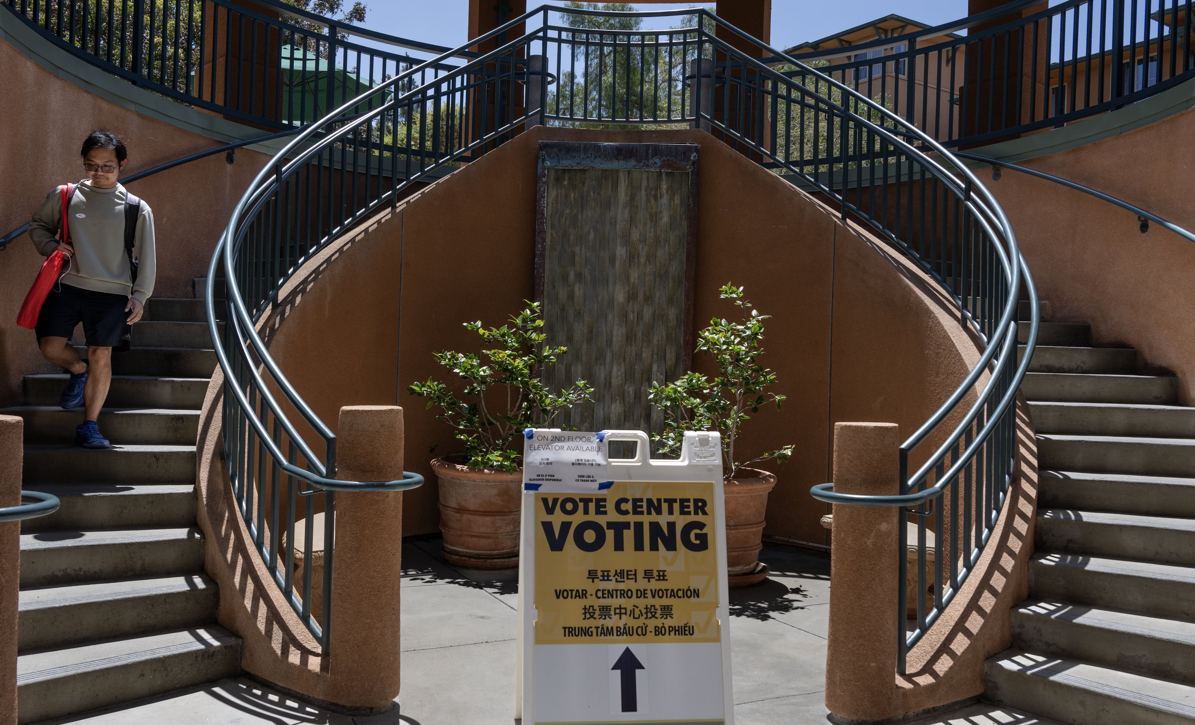 A sign directs voters to the polling center on the...