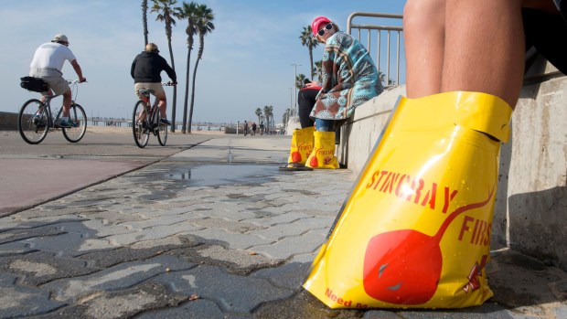 Bright yellow Sting ray first aid bags of hot water lined the area just outside the City of Huntington Beach Lifeguard Headquarters, where three people, who got stung in the afternoon, recovered in Jan. 2027. (Photo by Cindy Yamanaka, Orange County Register/SCNG)