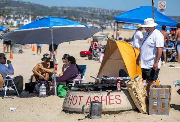 Beachgoers hang out by fire pits near the Balboa Pier in Newport Beach, where there are about 30 of them, on Saturday, June 20, 2026. (Photo by Jeff Antenore, Orange County Register/SCNG)