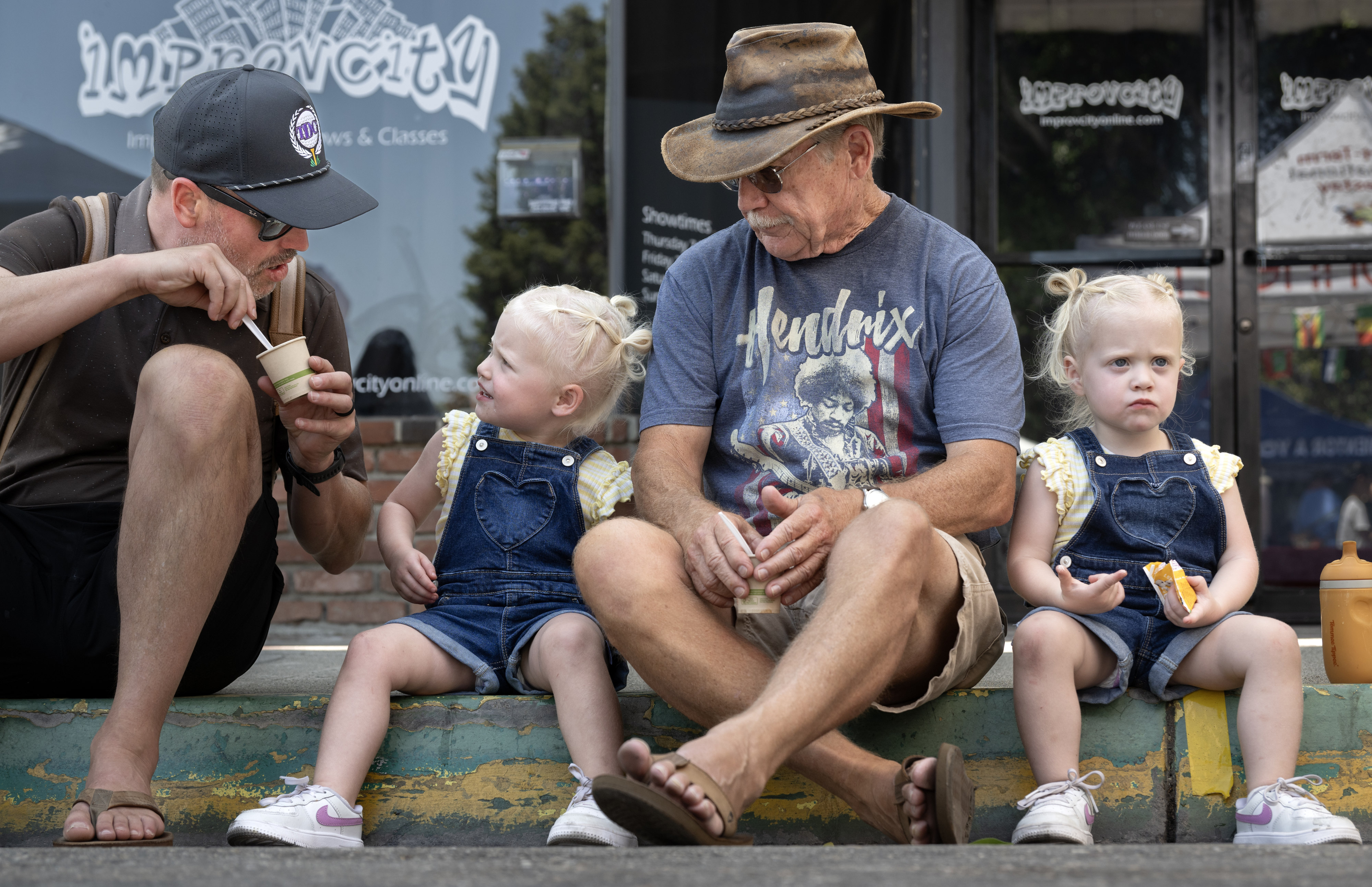Bryan Uecker, left, offers his daughter, Sailor, 2, some chili...