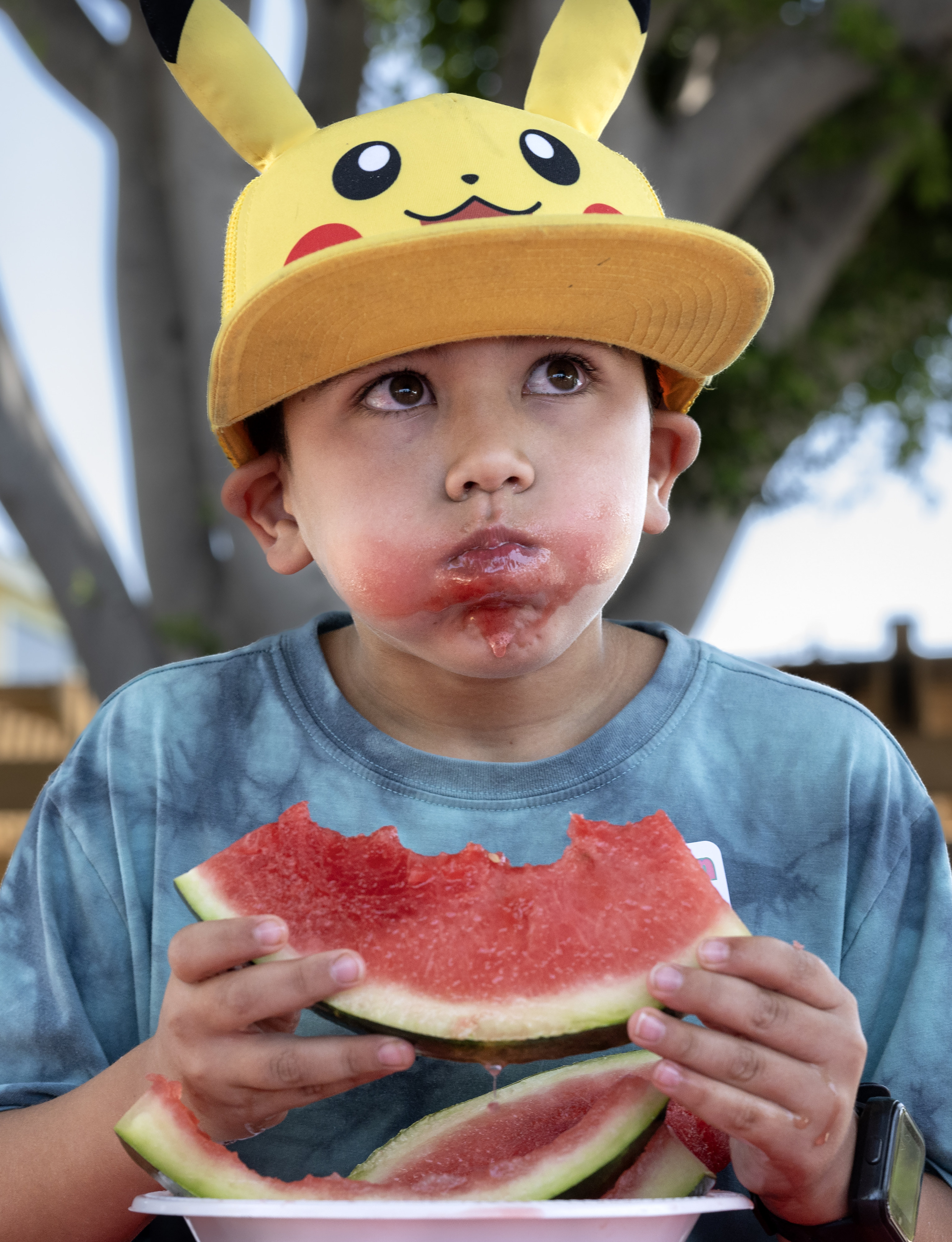 Jeff Bowers, 8, competes in the watermelon-eating contest during the...