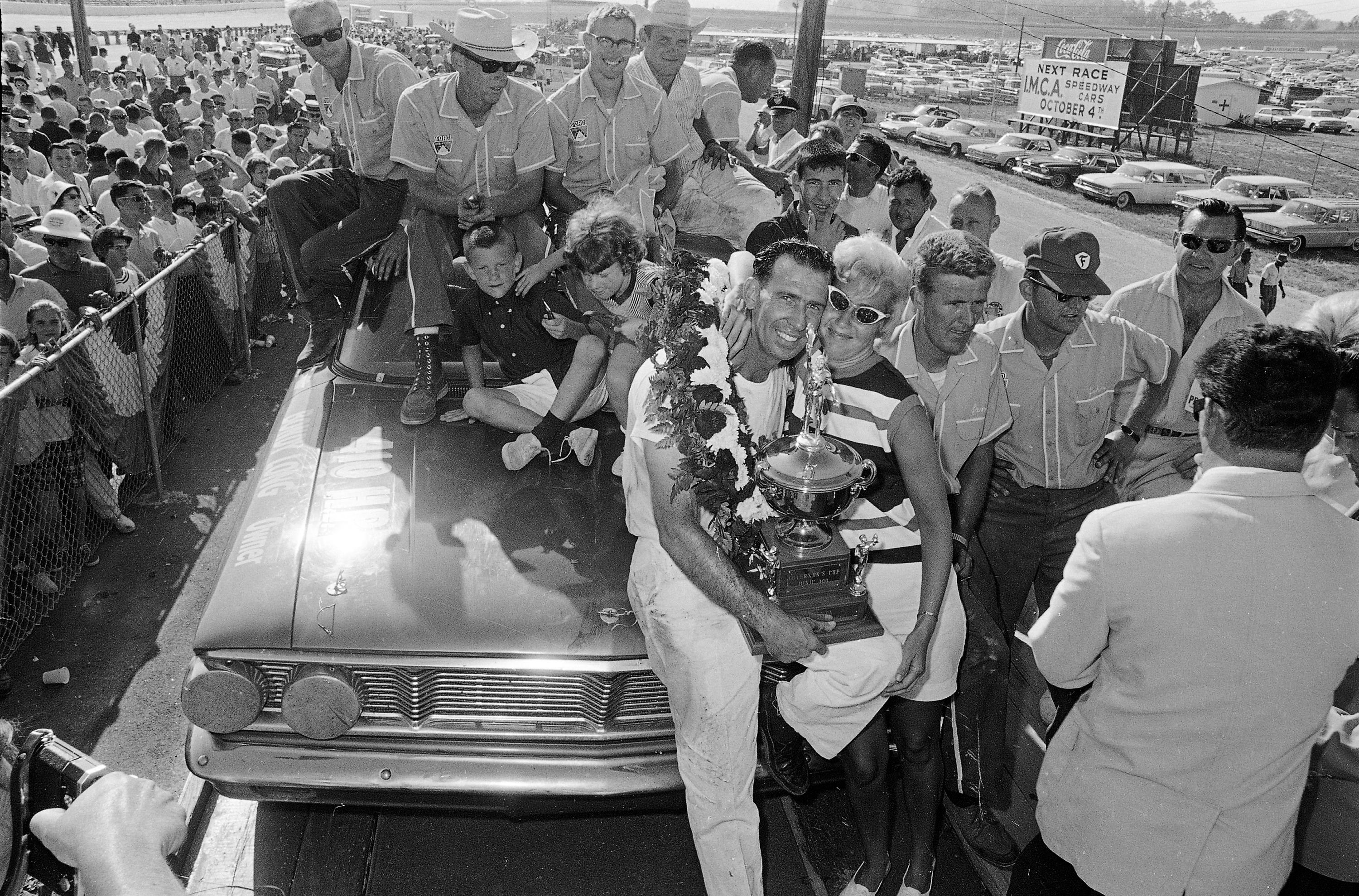 FILE- Ned Jarrett holds his trophy, The Governor’s Cup, as...