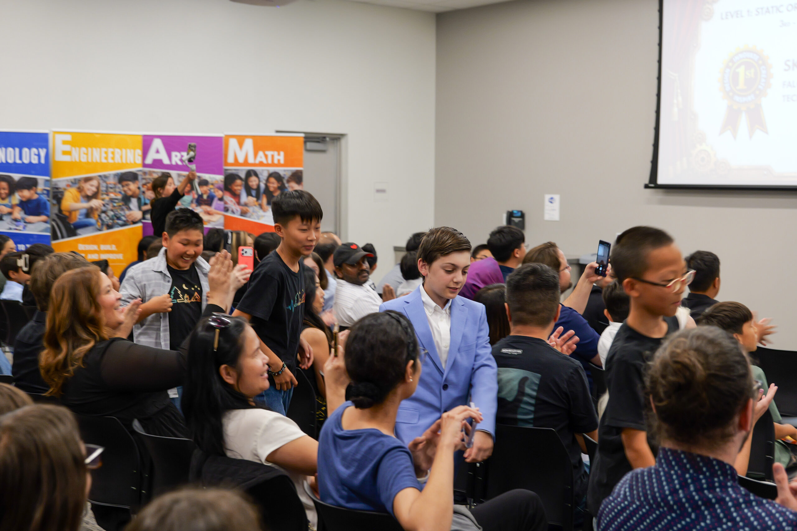 Brea Olinda Unified School District students Jacob, Thomas, Key and Minyu approach the stage at the ocMaker Challenge awards ceremony to accept first place in the static prototype category for the third- through fifth-grade level.