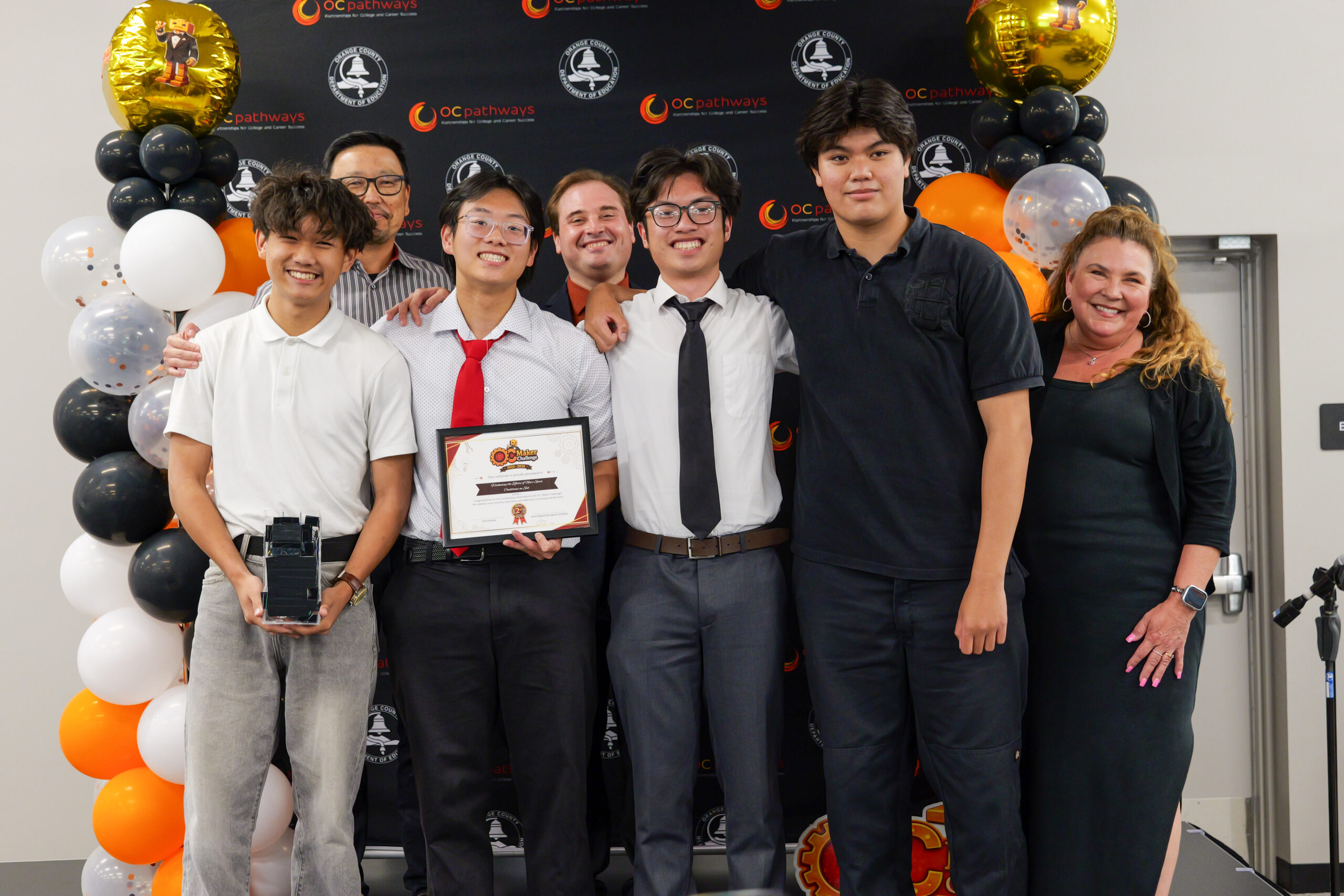 Westminster High School students David, Tyler, Brandon and Vincent receive second place in the static/non-functional prototype category for high school students at the ocMaker awards ceremony.