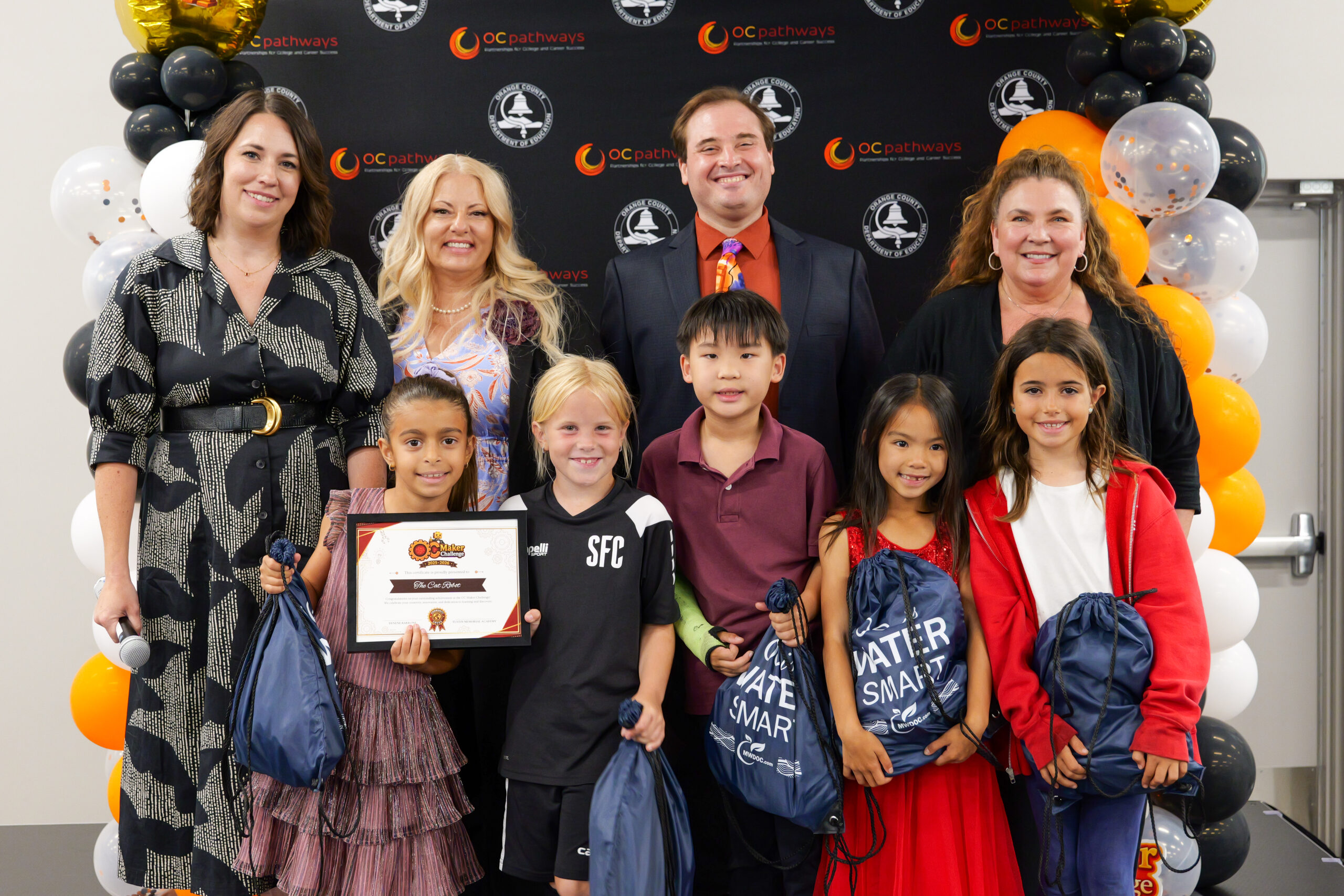 Tustin Memorial Academy students Vivienne, Cora, Miles, Maddie and Delnia win first place and the community-focused award from the Municipal Water District of OC for their dynamic prototype called "The Cat Robot."