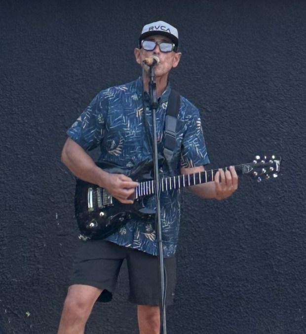 Ryan "Cappo" Kelley plays acoustic guitar and reggae music each Thursday evening during the Pacific Beach Night Market. (Madison Beveridge)