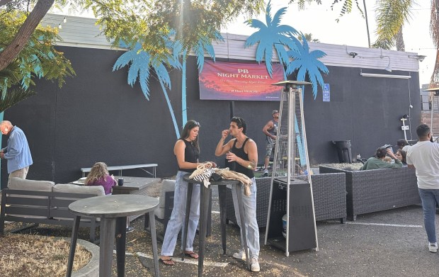 PB Night Market attendees eat and visit while listening to live music each Thursday evening. (Madison Beveridge)