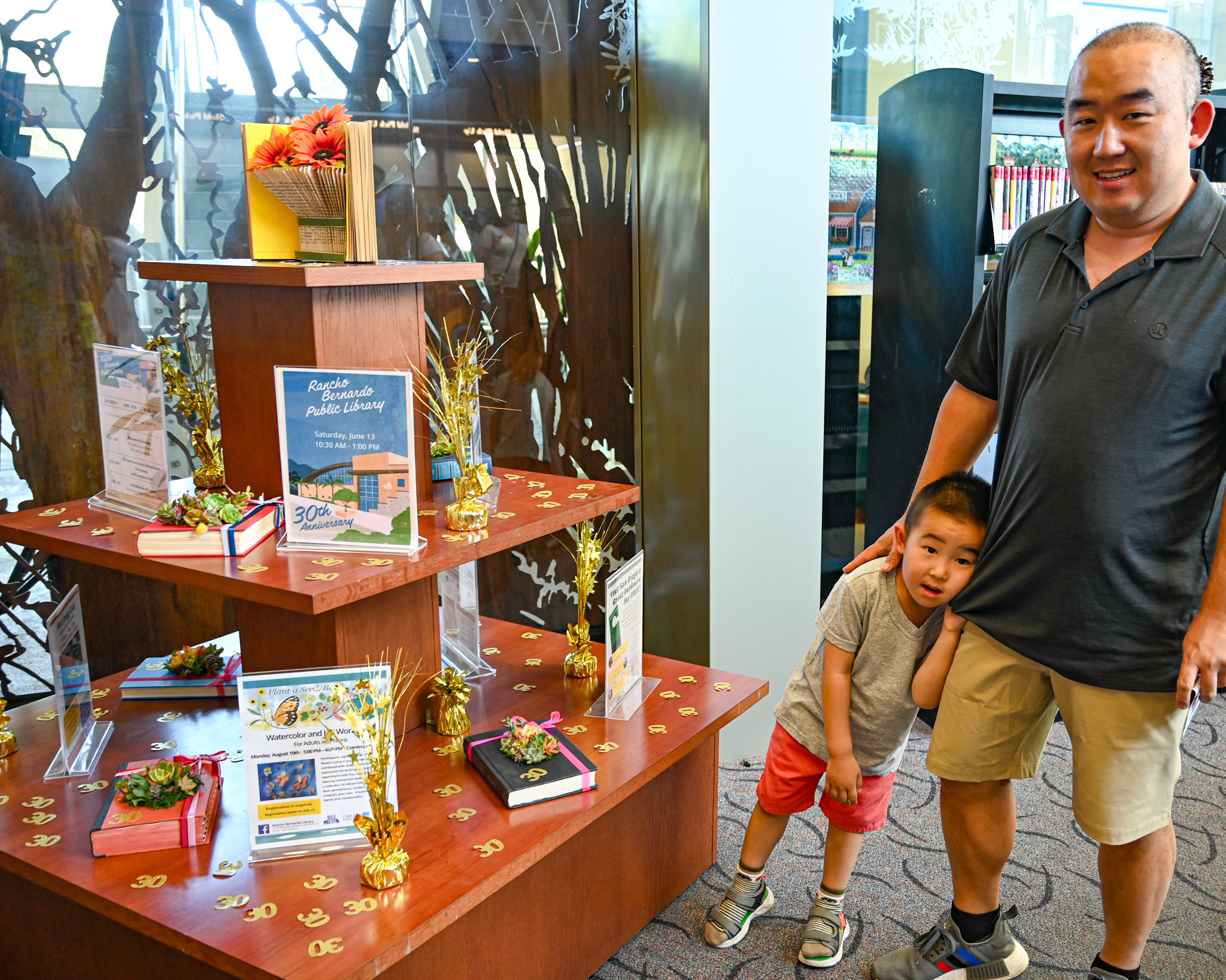 RB Library patron Chris Liu and his son Jasper standing...