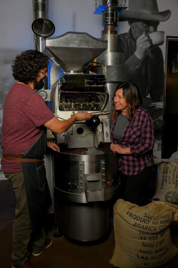 Weston and Samantha Nawrocki plan to expand their Manzanita coffee shops in Escondido and Rancho Bernardo with a Ramona location in late July or early August. They are shown here roasting their own coffee beans. (Courtesy Brant Bender)