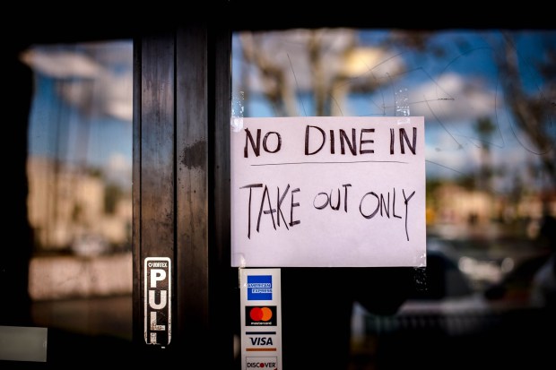 A notice is posted on the door at Rising Savor Chinese food in Riverside on Tuesday, March 17, 2020, notifying customers of disrupted the service due to outbreak of novel coronavirus (COVID-19). The City of Riverside ordered the temporary closure of restaurants dine-in service, and should be open only to drive-though or other pick-up/delivery options. (Photo by Watchara Phomicinda, The Press-Enterprise/SCNG)
