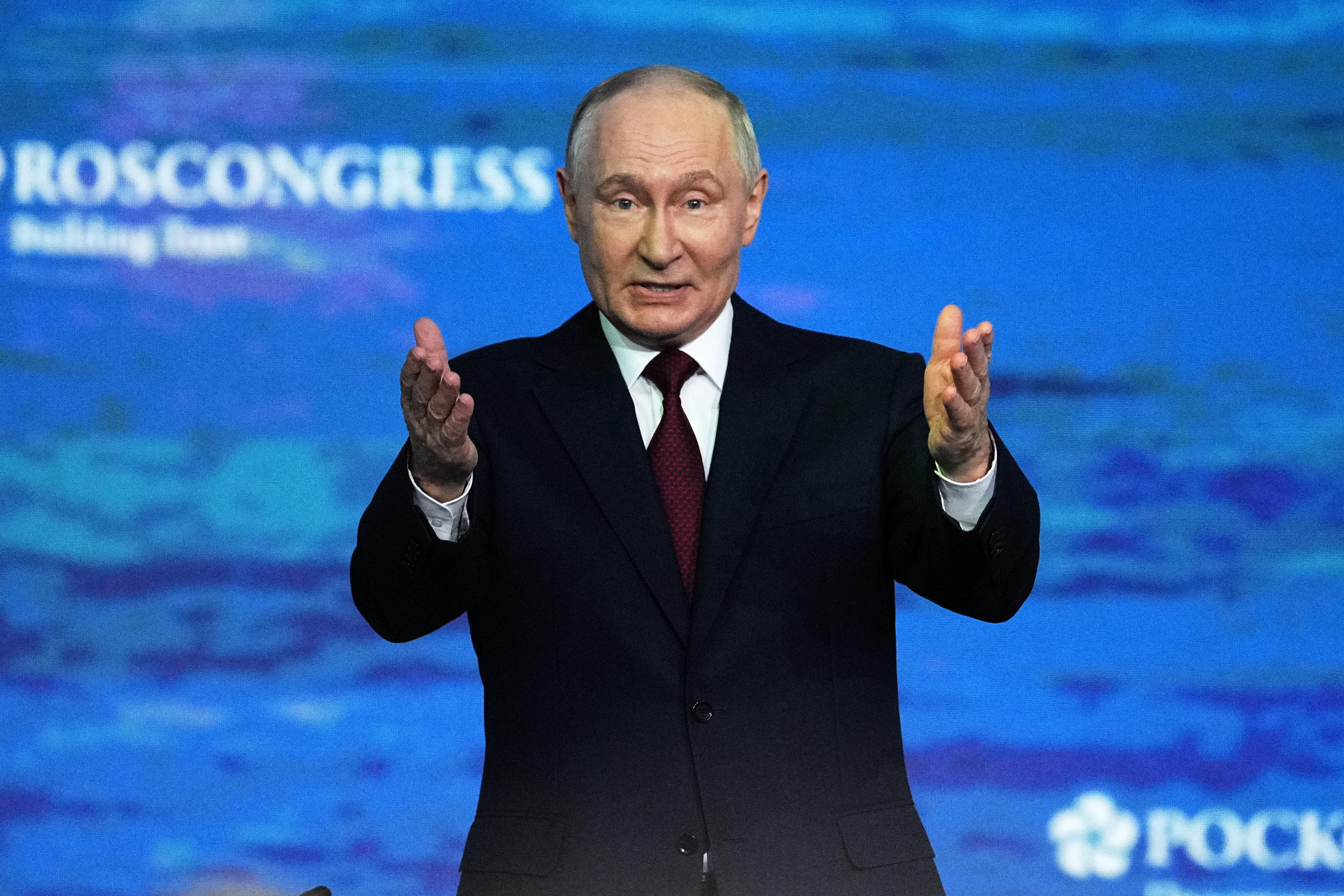 Russian President Vladimir Putin gestures