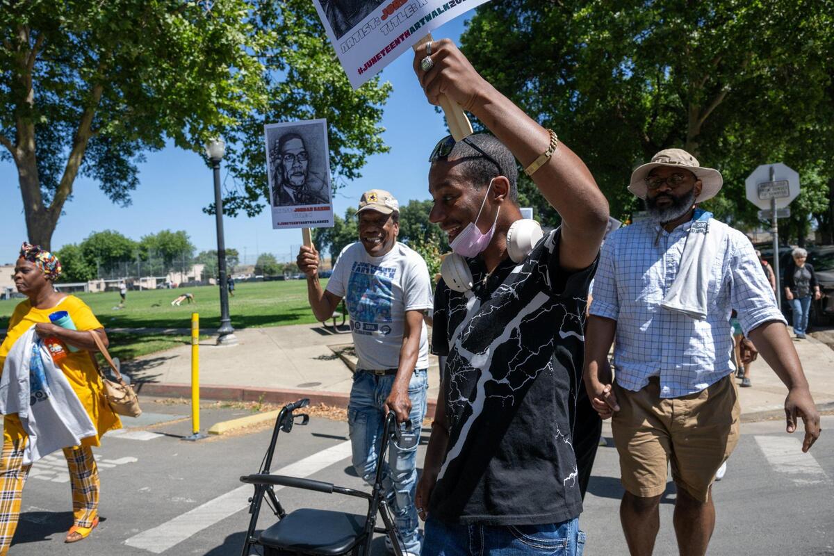 Joseph Trotter, left, using his walker, parades down the street to the music of the New Orleans-style Element Brass Band to the Capital Stage during the second annual Juneteenth Art Walk on Thursday, June 19, 2025, in Sacramento.