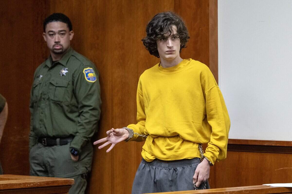 Bradley Sayer, the suspect in the Butte County Library shooting where two people were killed, makes a gesture as he appears for an arraignment hearing on Thursday at the Butte Superior Court in Oroville. He is charged with two counts of murder.