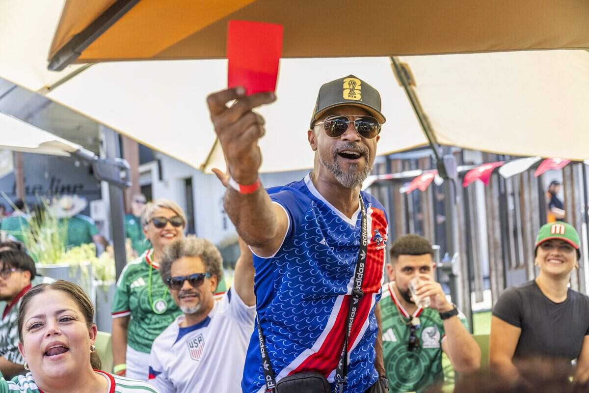 Rusty Clark, of Sacramento, pulls a red card during a watch party at Garden at the Line in Sacramento after Themba Zwane of South Africa received one in minute 84 of a World Cup match on Thursday.