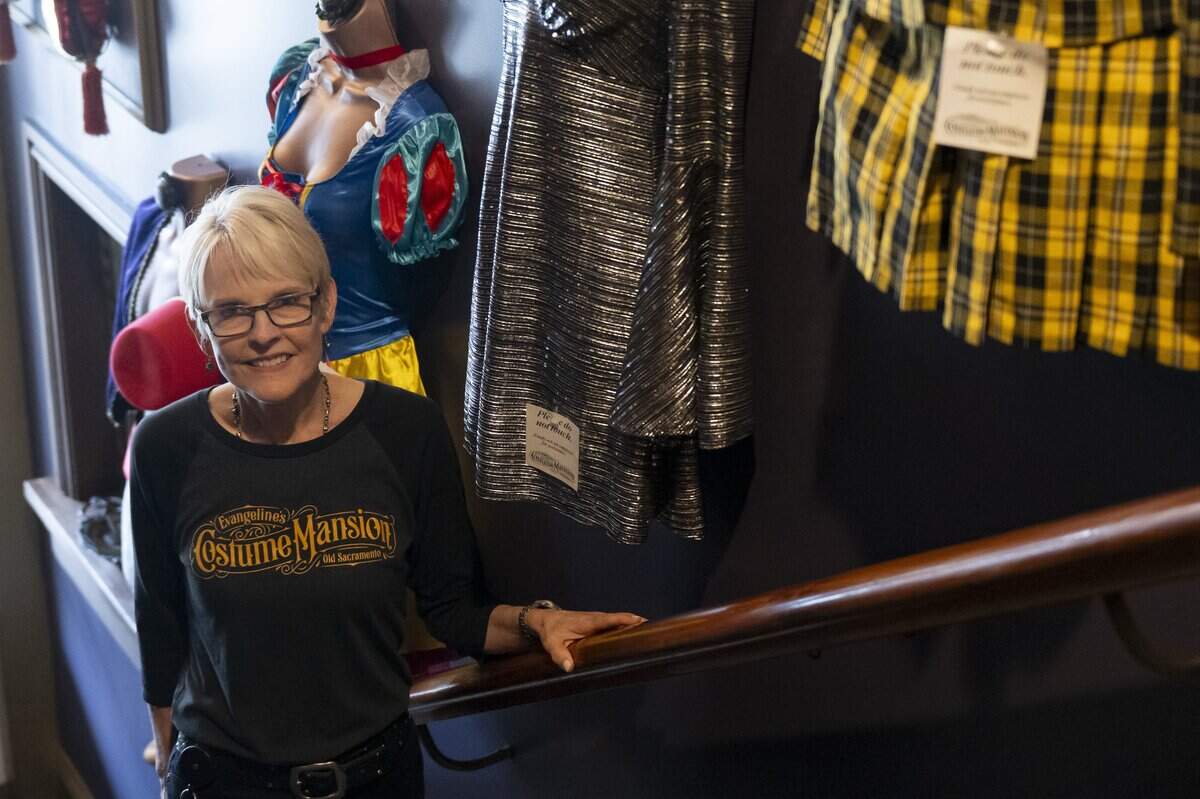 Evangeline’s Costume Mansion owner Deborah Chaussé poses for a portrait during the store’s grand reopening in Old Sacramento on Friday. The store was closed for just over a year due to fire damage.