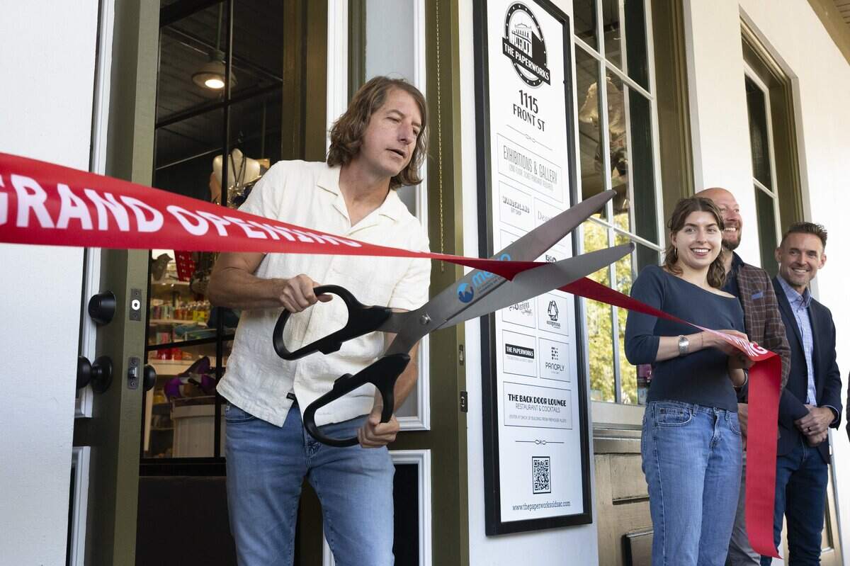 Stage Nine Entertainment/The Paperworks owner Troy Carlson cuts the ribbon to officially open The Paperworks in Old Sacramento on Friday.