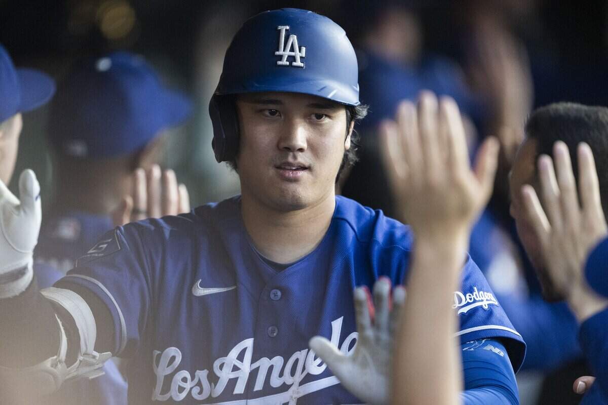 The Los Angeles Dodgers' Shohei Ohtani (17) celebrates with teammates after hitting a three-run home run against the Athletics on Monday at Sutter Health Park in West Sacramento.