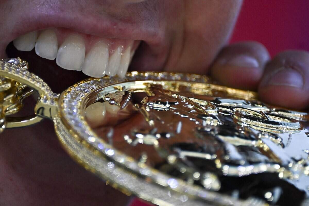 Gui Khury bites his gold medal after placing first in the MoonPay Men's Skateboard Vert Best Trick event at the MoonPay X Games in Sacramento on June 27, 2026.