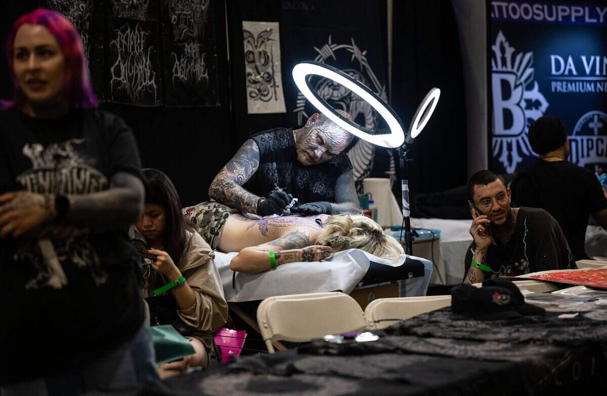 Rafel Delalande, with Seven Doors Tattoo of London, works on an extensive tattoo on Shy Snider’s back during the inaugural Capitol City Classic tattoo convention on May 6, 2022.