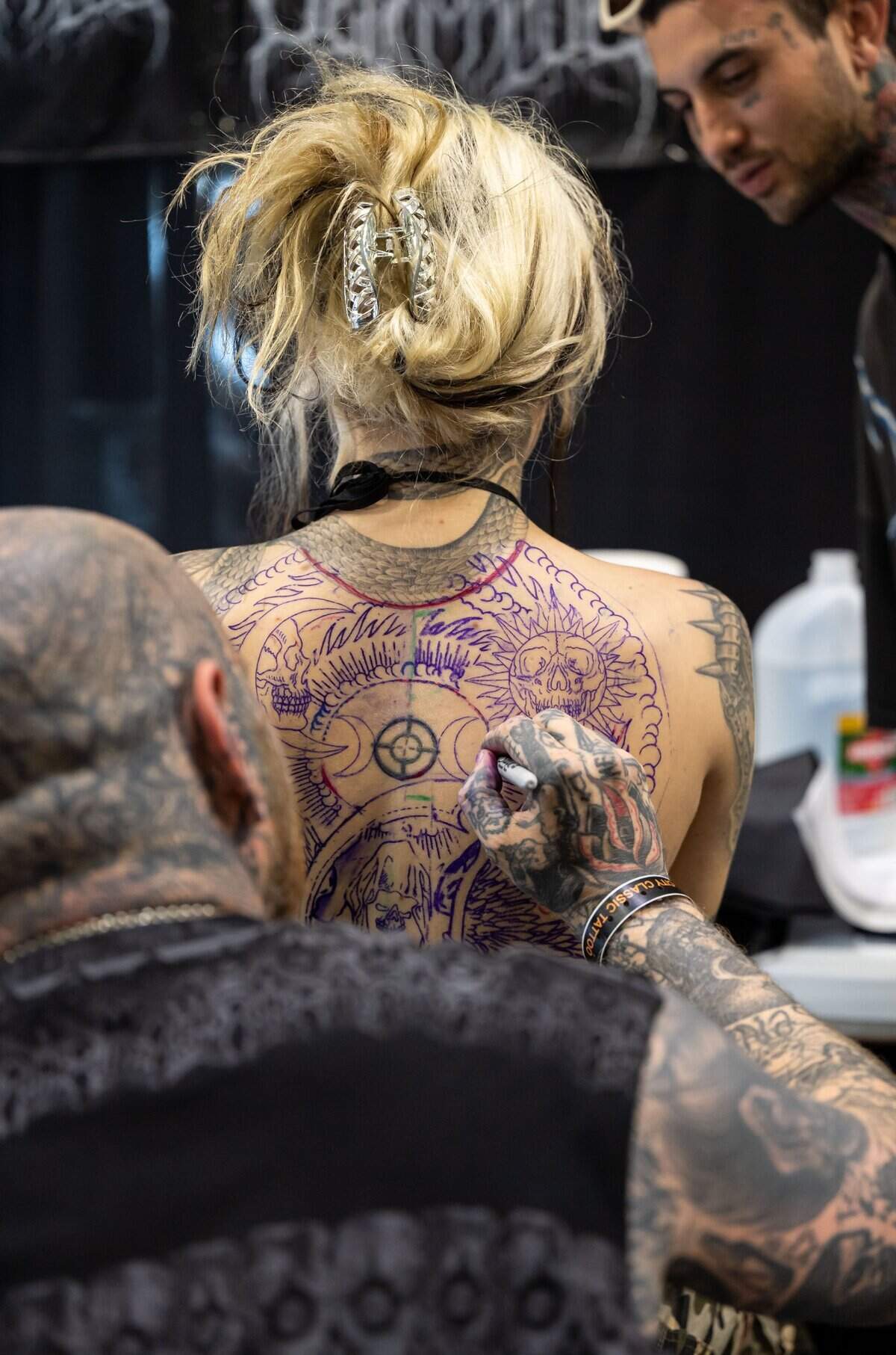 Rafel Delalande, with Seven Doors Tattoo of London, envisions a tattoo on Shy Snider’s back during the inaugural Capitol City Classic Tattoo Convention on Friday, May 6, 2022.