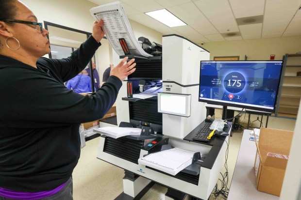 Elections seasonal clerk Sylvia Santiago-Mejia removes mail-in ballots from a machine after they were counted in the tabulation room at the Contra Costa County Registrar of Voters in Martinez, Calif., Friday, May 29, 2026. (Ray Chavez/Bay Area News Group)