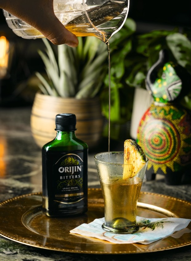 Tropical Noir, a cocktail by Oakland chef Nelson German, represents his Afro-Caribbean take on the Sazerac, featuring cinnamon-charred pineapple, an absinthe wash, rye whiskey, Nigerian Orijin bitters and more. He shares the recipe in his new cocktail cookbook, "Caribbean Cocktails" (Ten Speed Press, $24). (Photo courtesy of Eduardo Gonzalez)