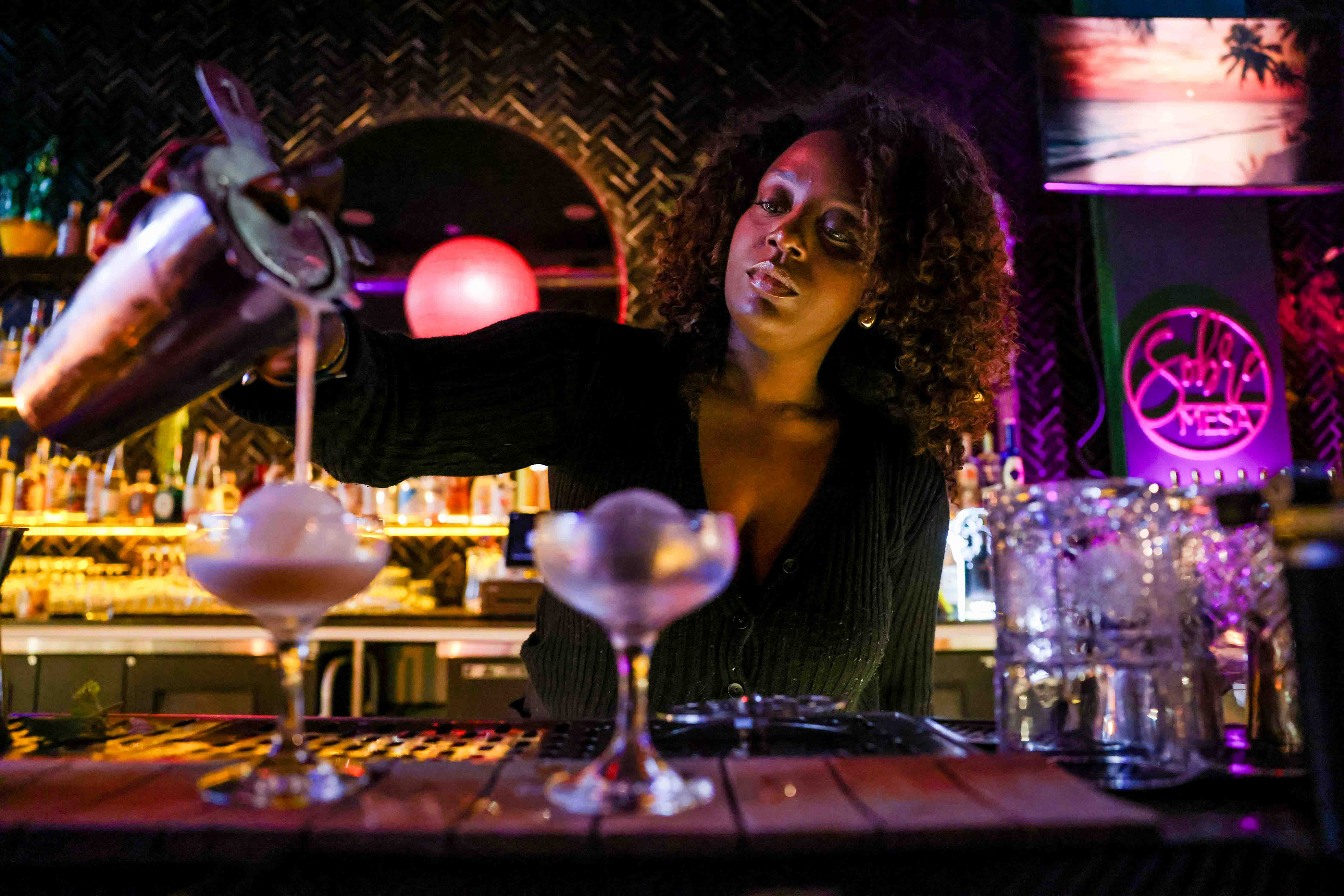 Bartender Anissa Kiyenba makes welcoming drinks named Nelsons, inspired by...