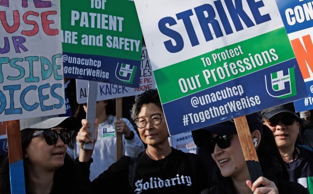 File photo of healthcare professionals at Kaiser PermanenteÕs Santa Clara Medical Center displaying signs on the first day of their strike in January of this year.(Dai Sugano/Bay Area News Group)
