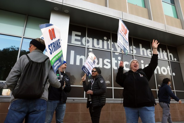 File photo of medical workers and their supporters walking the picket line outside of the Kaiser Oakland Medical Center on the first day of their strike in January of this year. Thousands of striking workers, who are represented by United Nurses Associations of California/Union of Health Care Professionals, went on strike indefinitely amid stalled labor negotiations. (Aric Crabb/Bay Area News Group)
