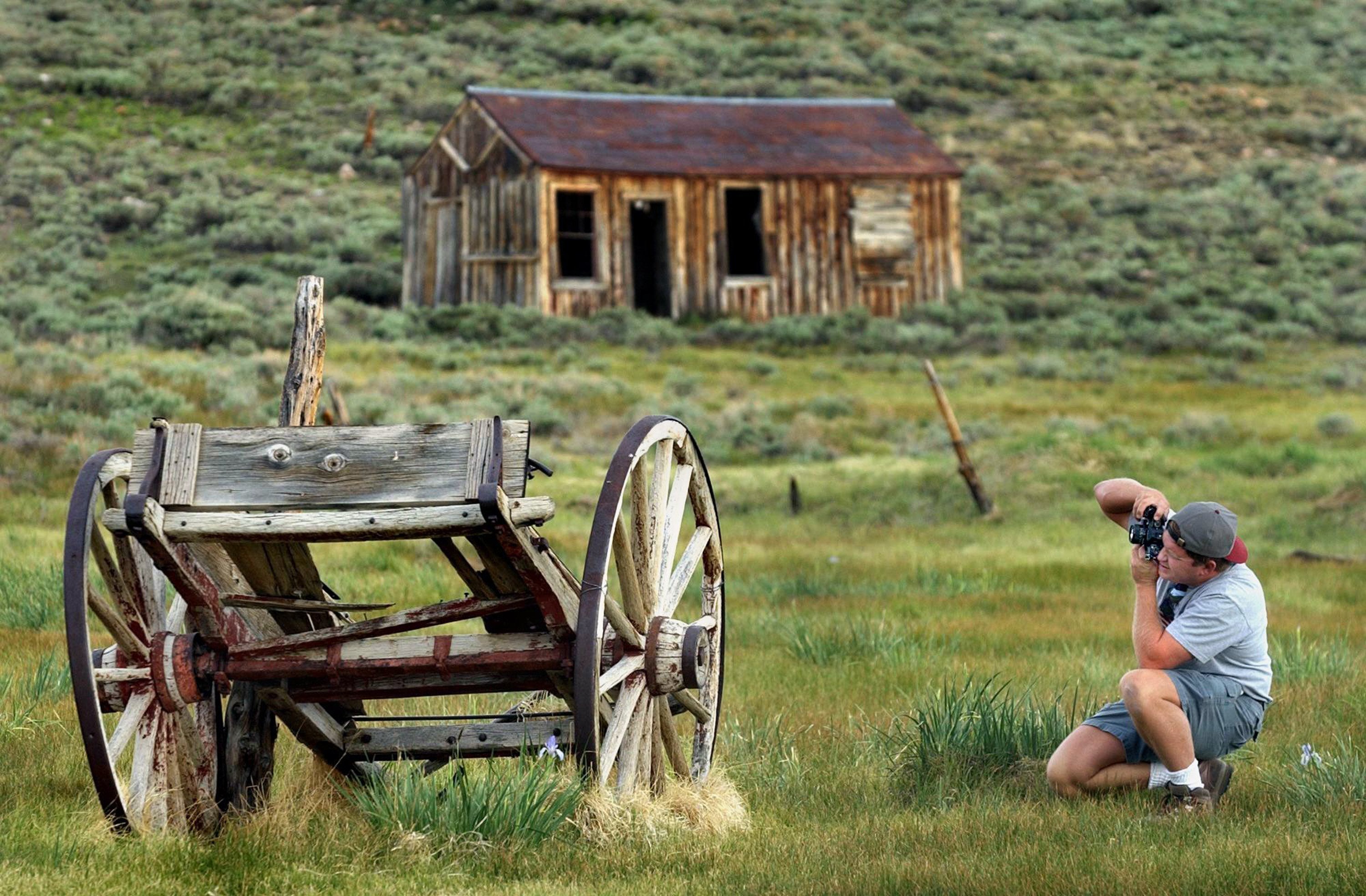 Jay Talbert photographs an old wagon at the Bodie State...
