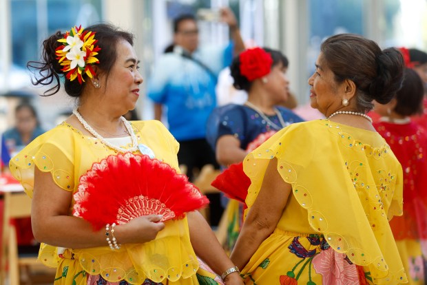 Letty Oineza, of San Jose, left, and Josie Santos, of San Jose, right, dance with the FilCal Heritage Dancers during a celebration of Philippine Independence Day at San Jose City Hall in downtown San Jose, Calif., on Friday, June 12, 2026. (Shae Hammond/Bay Area News Group)