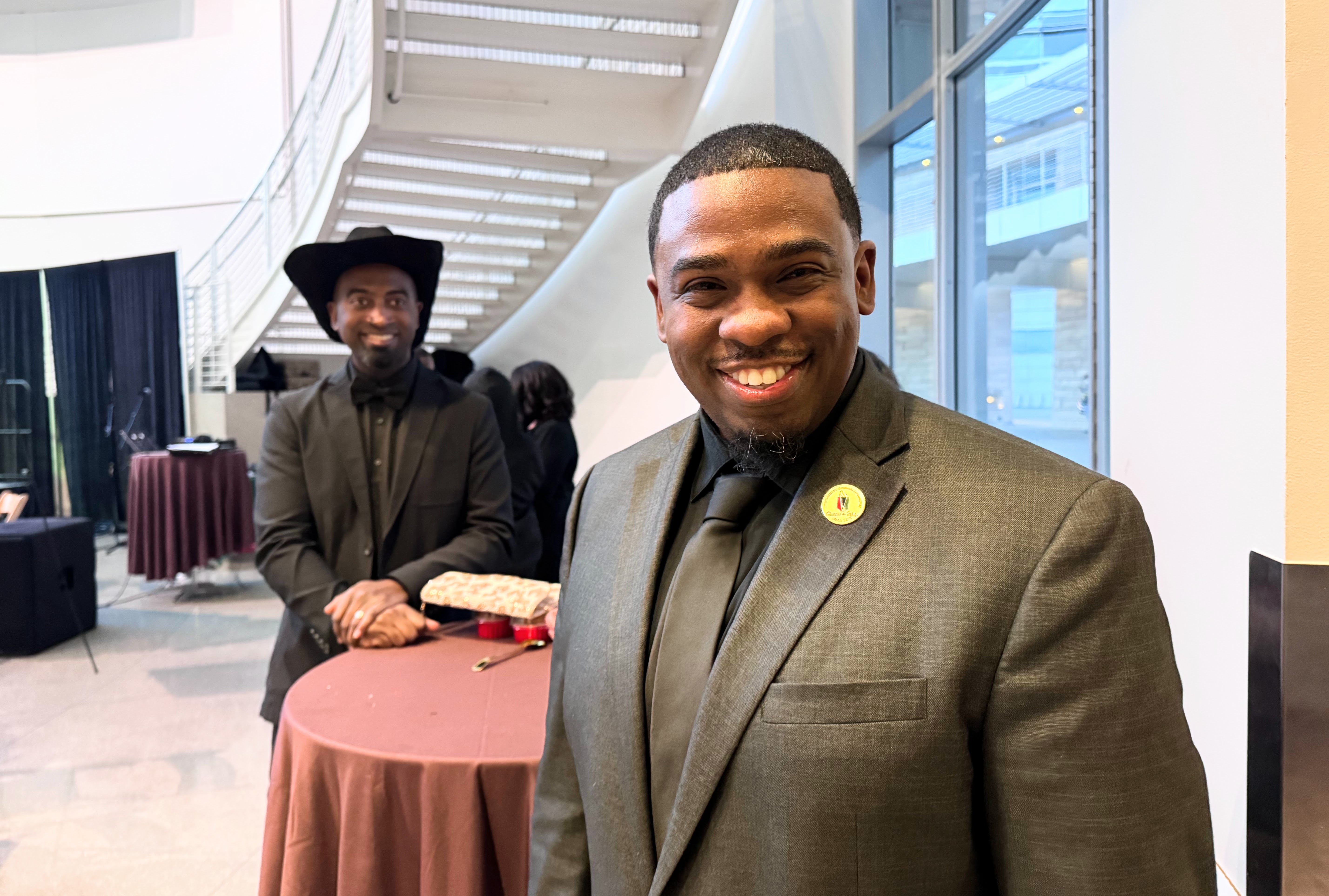 African American Community Service Agency Executive Director Milan Balinton, front,...