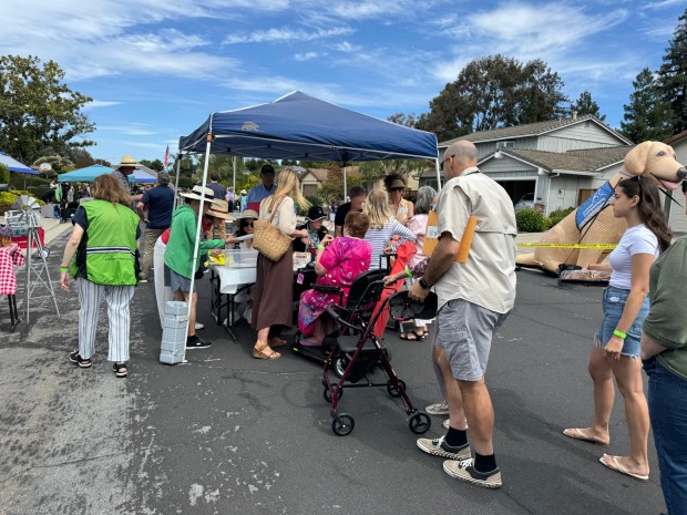 Neighbors line up to check in at a block party celebrating the 50th anniversary of the Laurel Park East neighborhood in Santa Clara on Saturday, June 6, 2026. (Photo by Susan Peters)