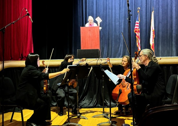 Gloria Duffy addresses the audience as a string quartet from Symphony San Jose prepares to play the Navy Hymn at the celebration of life for her husband, Rod Diridon Sr., at the San Jose Civic Auditorium on Thursday, June 25, 2026. (Sal Pizarro/Bay Area News Group)