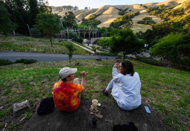 Craig Cannon, of Berkeley, sits with his wife Eva Mak on a hillside overlooking the Siesta Valley Bowl in Orinda, Calif., on Friday, June 5, 2026. (Jose Carlos Fajardo/Bay Area News Group)