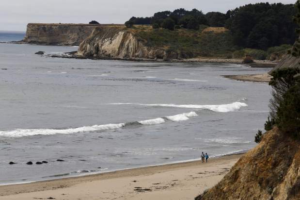 A couple walks on Bowling Ball Beach, part of Schooner Gulch State Beach on Sunday, June 28, 2015 south of Point Arena. (BETH SCHLANKER / The Press Democrat)