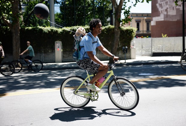 Jamari Ducre rides with Frizzle, a 1-year-old mix, south on South Market Street during Viva CalleSJ's "Greetings from San Jose" in downtown San Jose, Calif., on Sunday, June 14, 2026. (Nhat V. Meyer/Bay Area News Group)