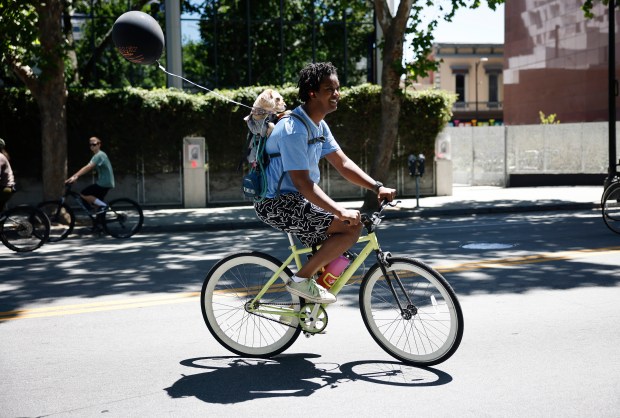 Jamari Ducre rides with Frizzle, a 1-year-old mix, south on South Market Street during Viva CalleSJ's "Greetings from San Jose" in downtown San Jose, Calif., on Sunday, June 14, 2026. (Nhat V. Meyer/Bay Area News Group)